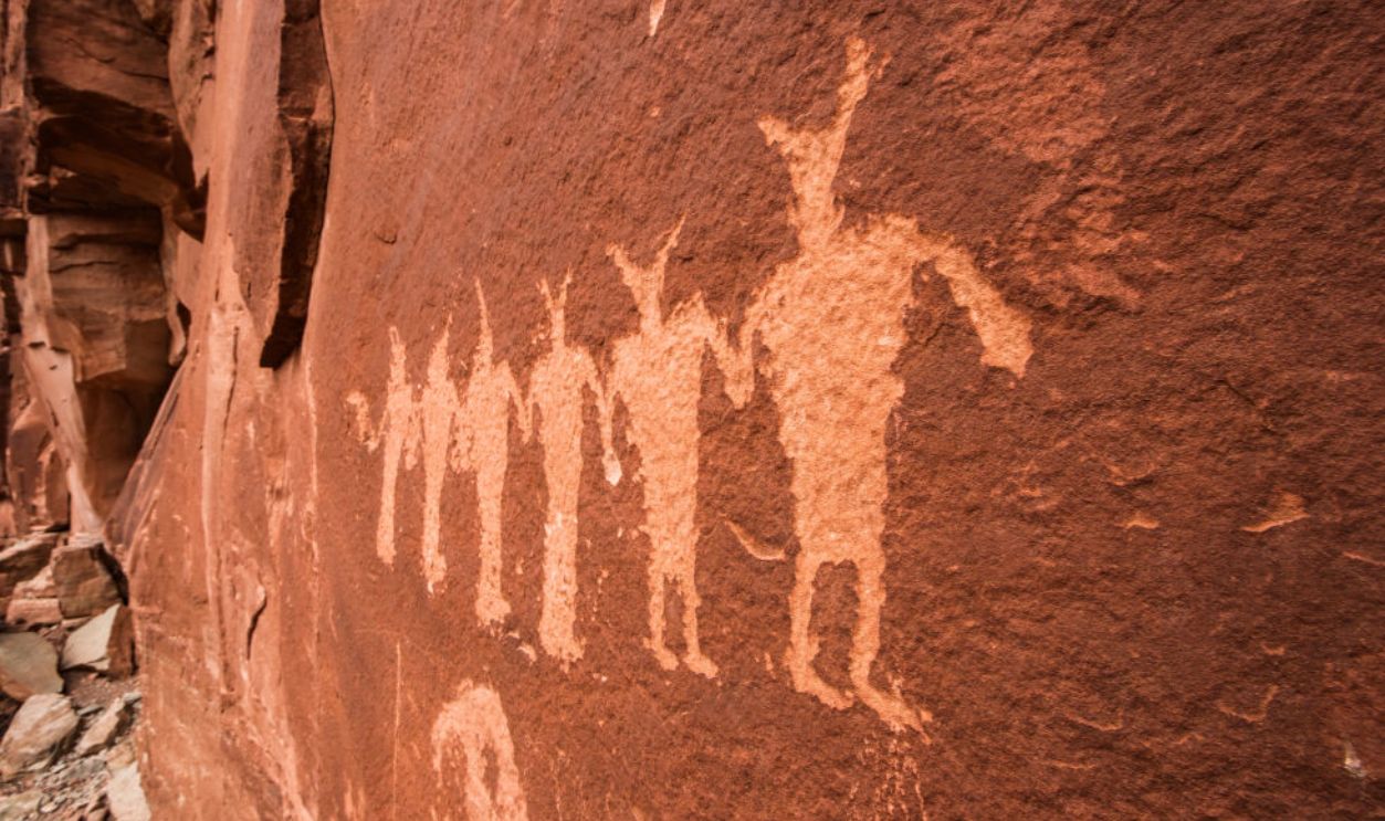 1449663295 - Dancers depicted on the Poison Spider Mesa Panel, a Fremont Culture Native American rock art panel near Moab, Utah