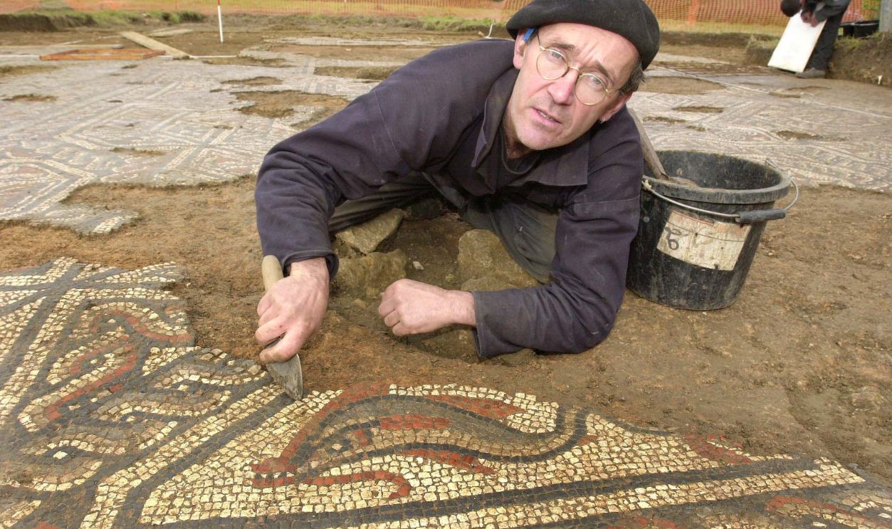 Archaeologist Alan Graham working on the dolphin part of the Roman mosaic unearthed at Lopen near Ilminster, Somerset. The artwork, which was discovered accidentally by workmen, has been called one of the most important archaeological finds from the fourth century. *... in the past 50 years. The 1,640-year old mosaic pavement, is said to be rare for Britain, as part of the tiles depict a dolphin rather than the more usual geometric designs found across the South West. Archaeologists are planning to rebury the pavement, made of red, white and blue blocks of Somerset limestone and tiles, to protect it during the winter. 