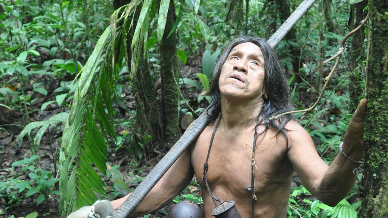 Huaorani man with his blow pipe and Squirrel Monkey