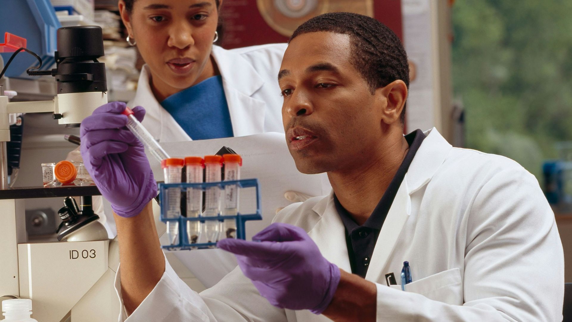 man in white chef uniform holding purple plastic bottle