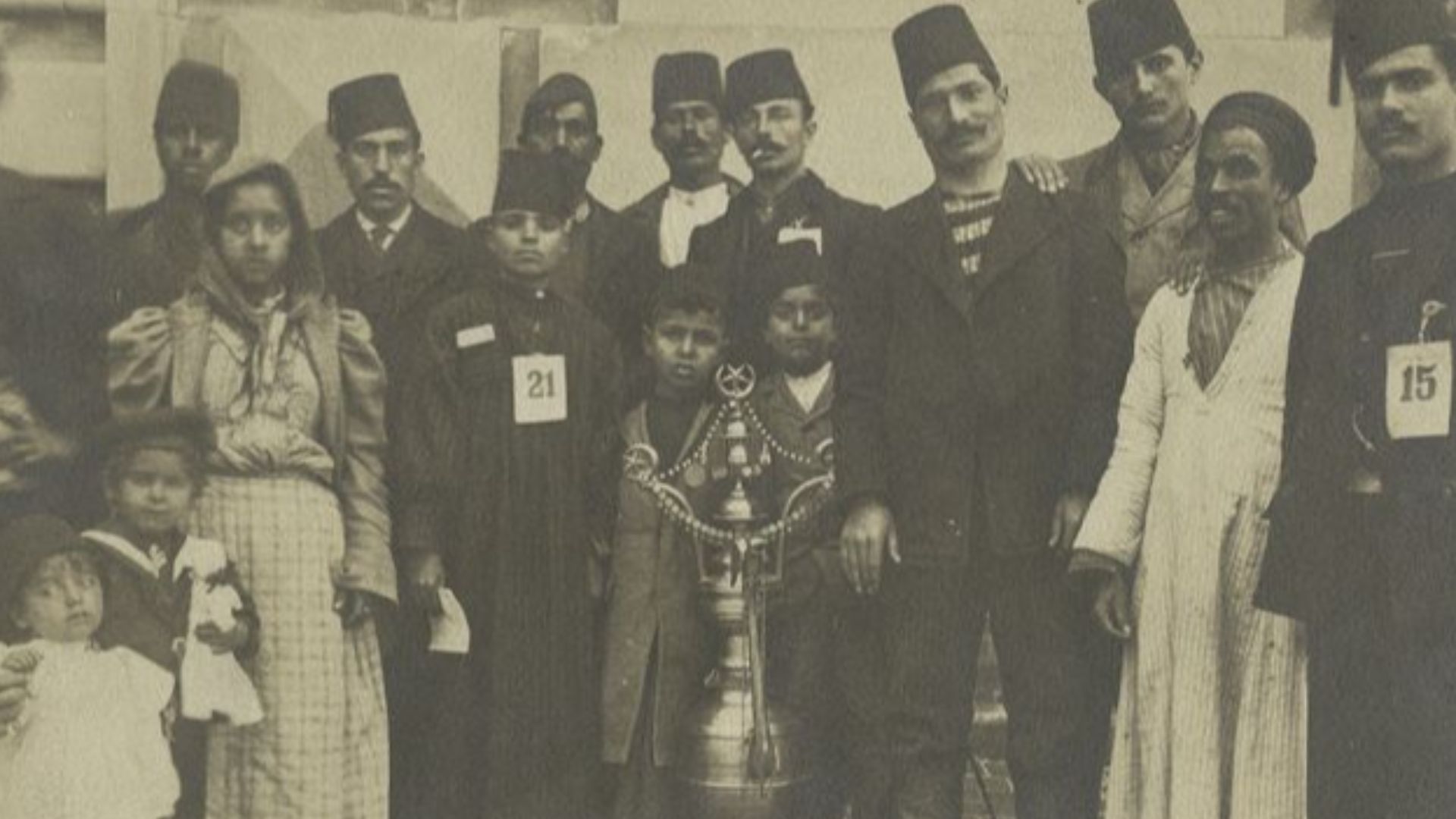 File:A group of immigrants, most wearing fezzes.jpg