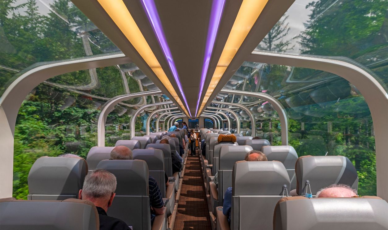 Interior of the gold leaf Rocky Mountaineer train wagon or carriage with tourists between Vancouver and Jasper, British Columbia, Canada.