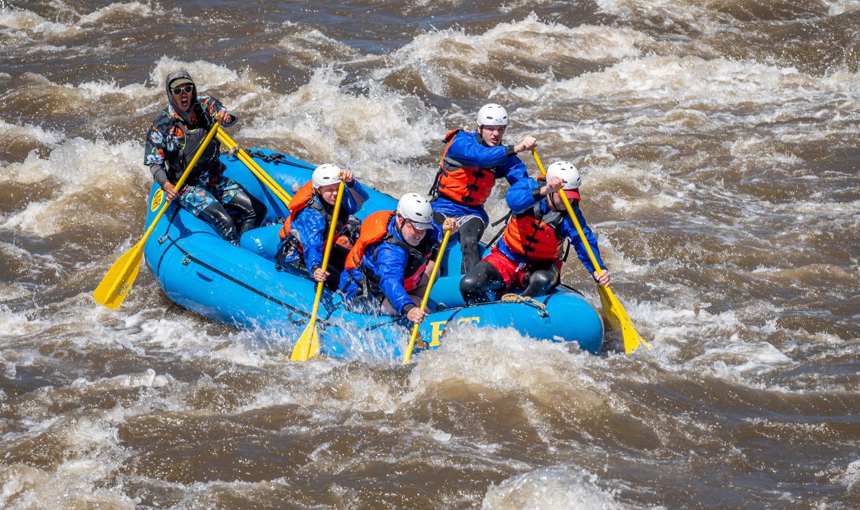 Small groups of people in inflatable rafts, enjoying the challenge of the whitewater rapids on the Arkansas River through Bighorn Canyon near Canon City on Memorial Day, 2023 after a winter and spring of abnormally high precipitation.