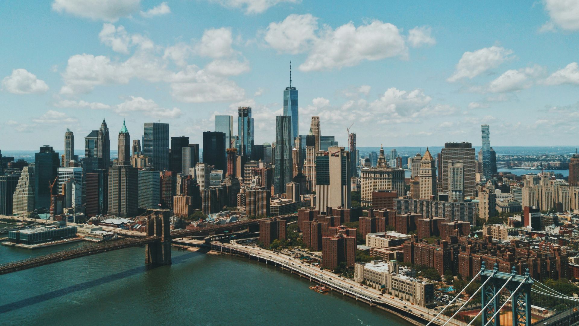 wide angle photo of Brooklyn Bridge under cloudy sky