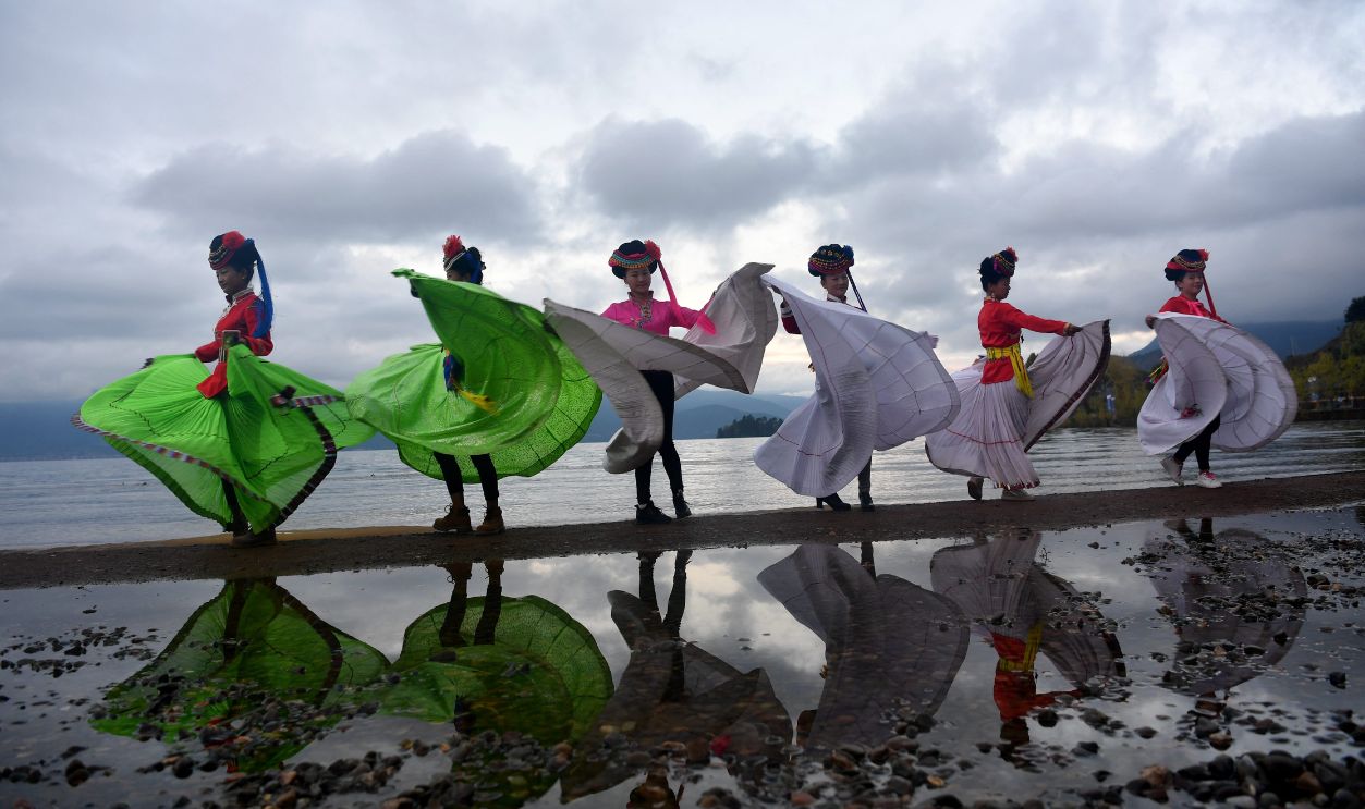 Women of Mosuo ethnic group dance at Lugu Lake area on October 15, 2017 in Liangshan Yi Autonomous Prefecture, Sichuan Province of China. Lugu Lake is called the 'mother lake' by the Mosuo people and it becomes 'the Kingdom of Women' and 'Home of the Matriarchal Tribe'.