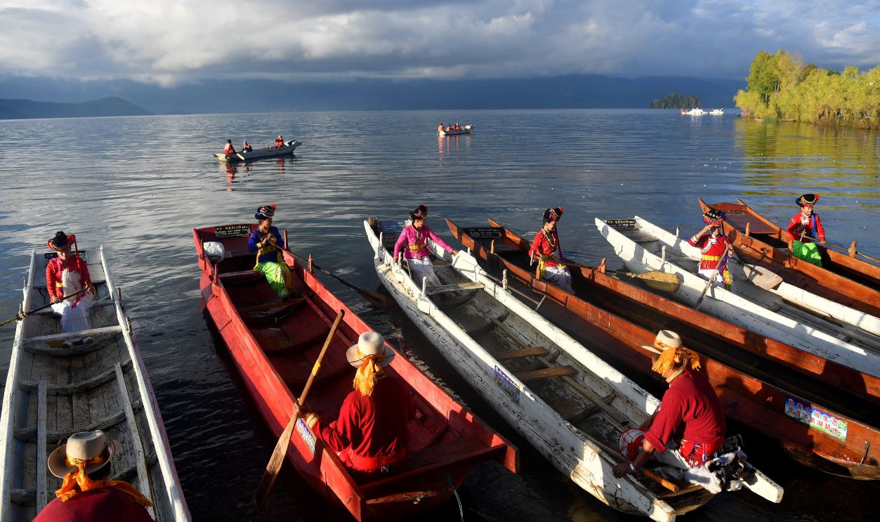 Women of Mosuo ethnic group row boats at Lugu Lake area on October 15, 2017 in Liangshan Yi Autonomous Prefecture, Sichuan Province of China. Lugu Lake is called the 'mother lake' by the Mosuo people and it becomes 'the Kingdom of Women' and 'Home of the Matriarchal Tribe'. 