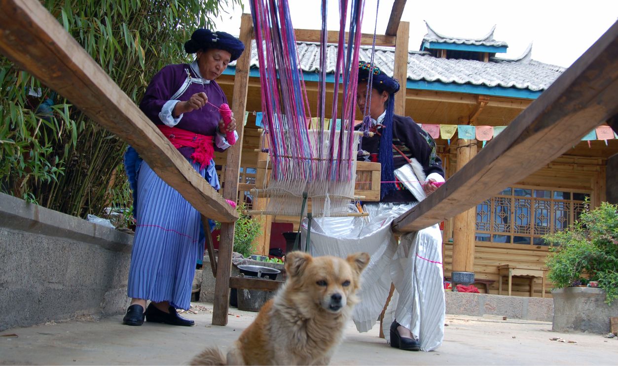 Women of Mosuo ethnic group do handwork at Lugu Lake area on May 01, 2010 in Ninglang Yi Autonomous County, Yunnan Province of China. Lugu Lake is called the 'mother lake' by the Mosuo people and it becomes 'the Kingdom of Women' and 'Home of the Matriarchal Tribe'.