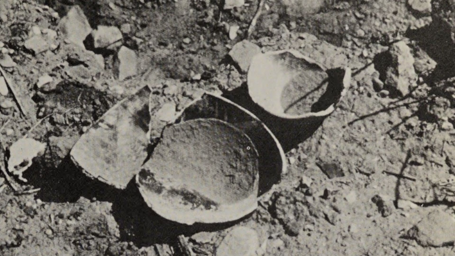 File:Plundered Native American grave site with broken pottery.png