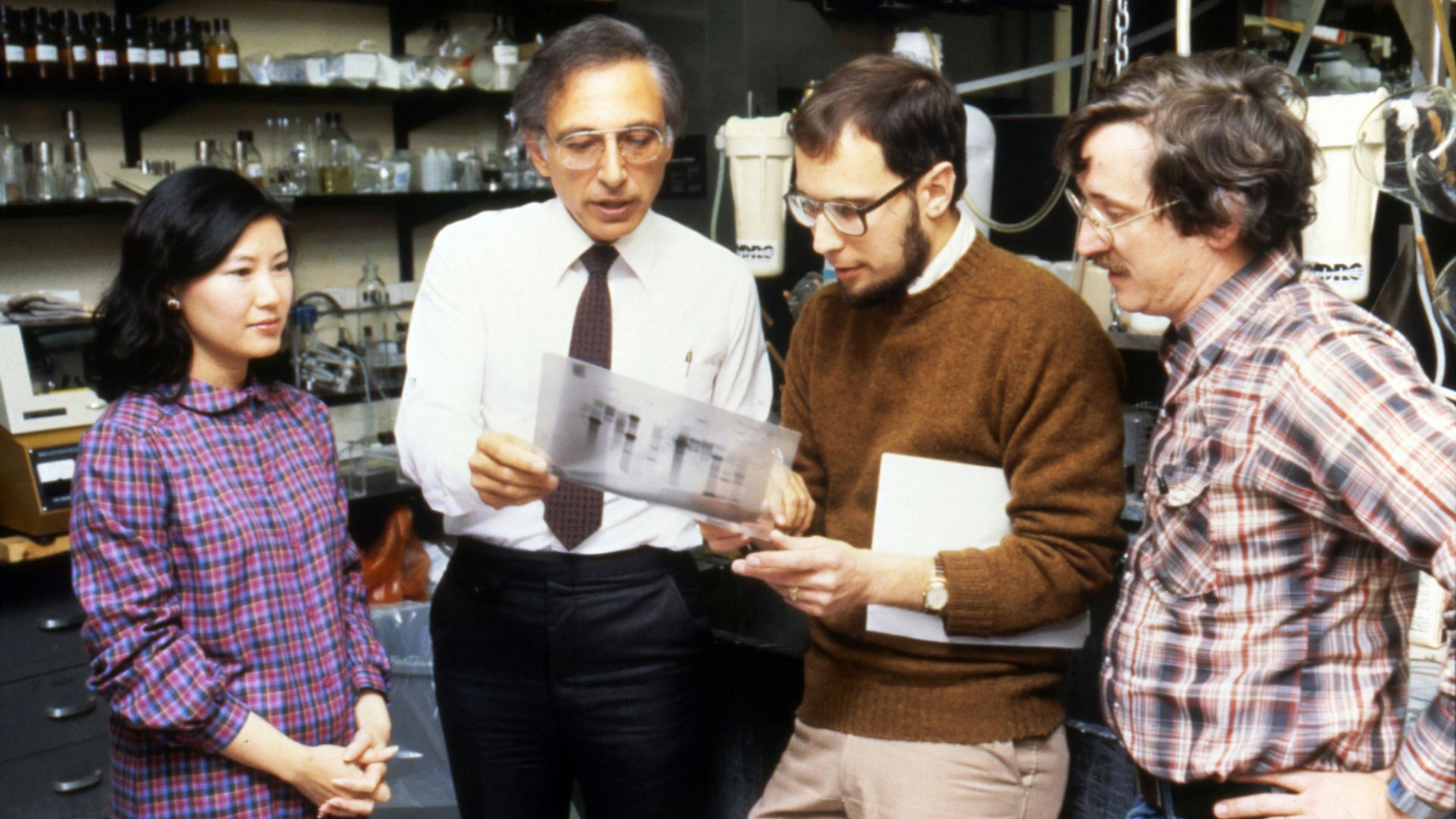 three men standing beside woman
