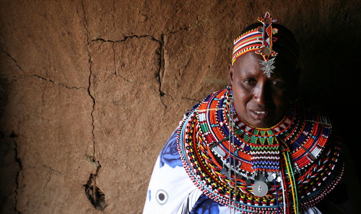 Rebecca Lolosoli, the matriarch of an all-female village in Kenya that offers a haven to those fleeing forced marriages or abuse, sits with a group of women and children. Ten years ago, a group of women established the village of Umoja, which means 