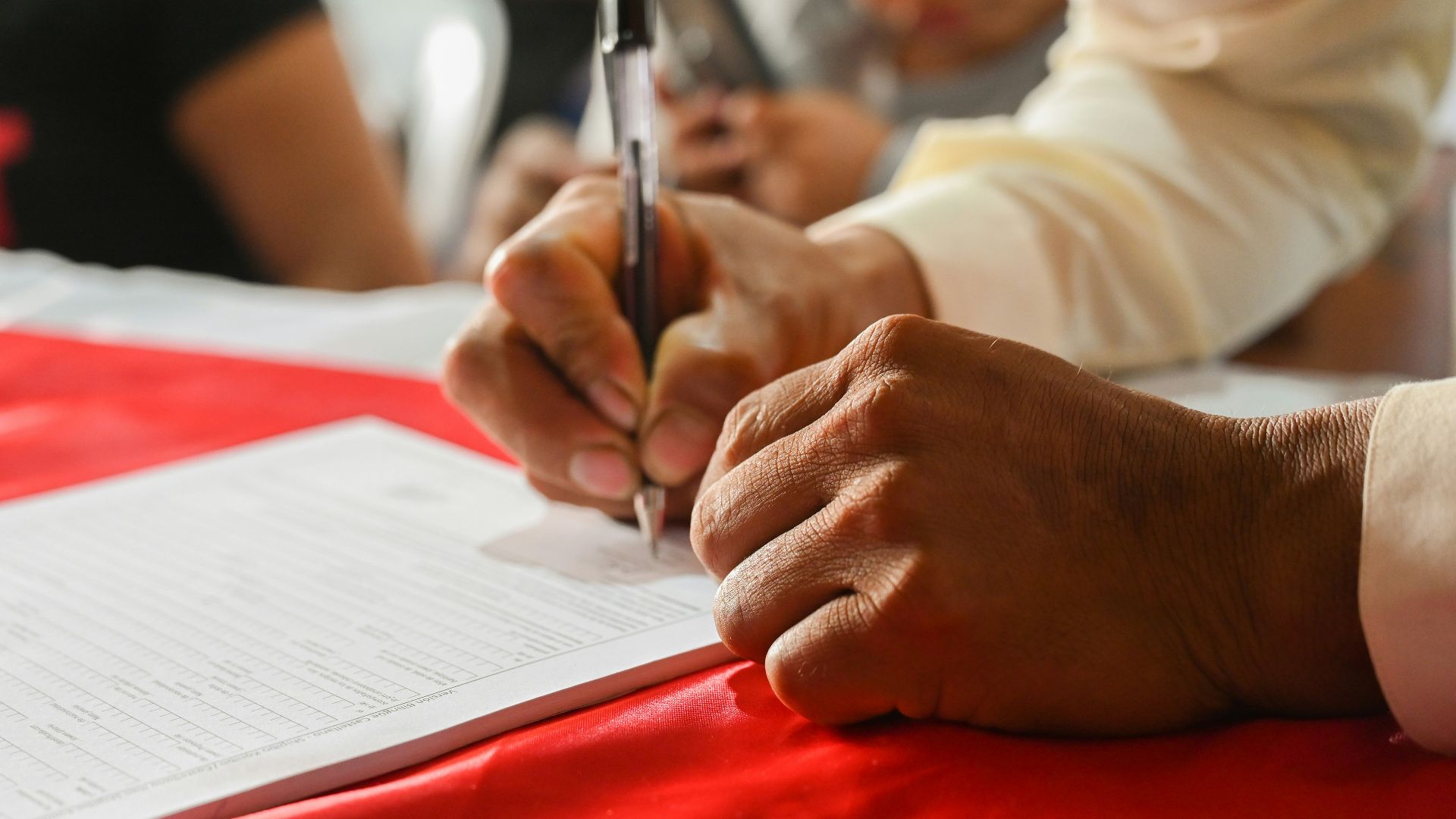 a person writing on a piece of paper