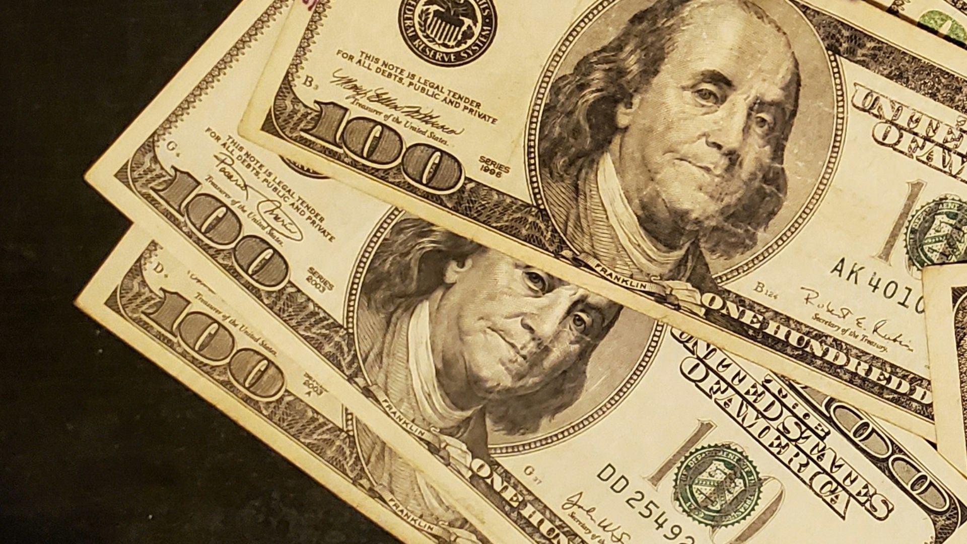 a pile of twenty dollar bills sitting on top of a table