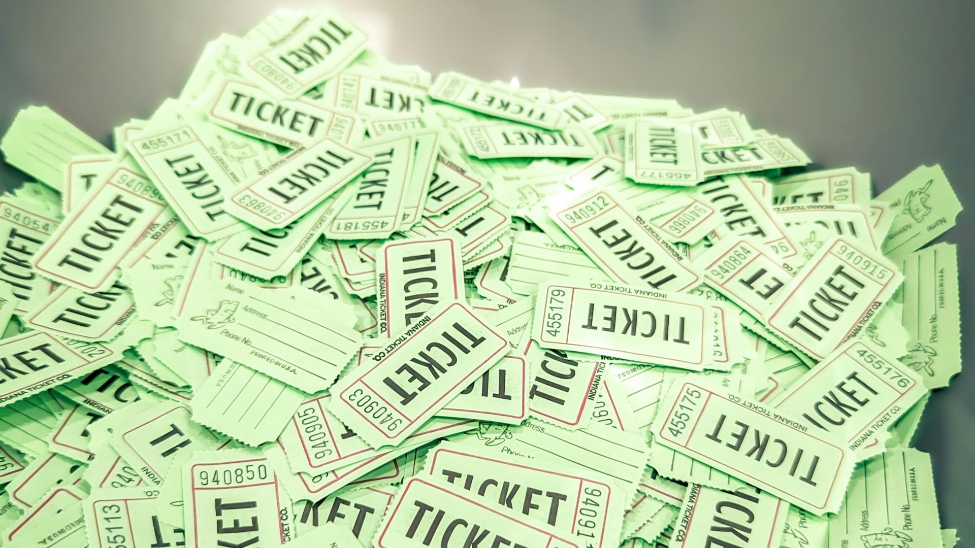 a bowl full of tickets sitting on top of a table