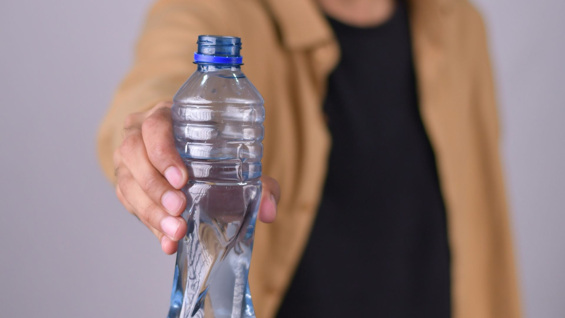 a man holding a bottle of water in his hand