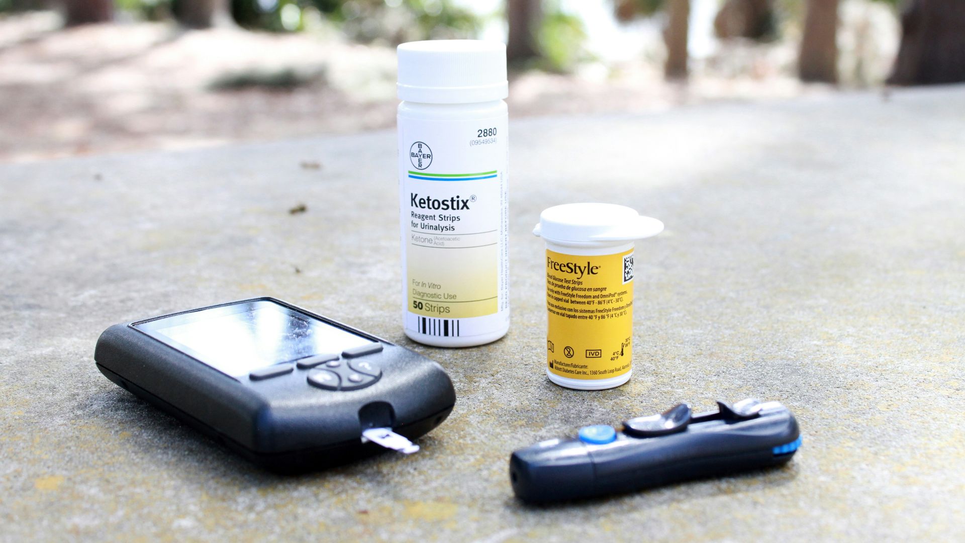 black smartphone beside white plastic bottle and black smartphone