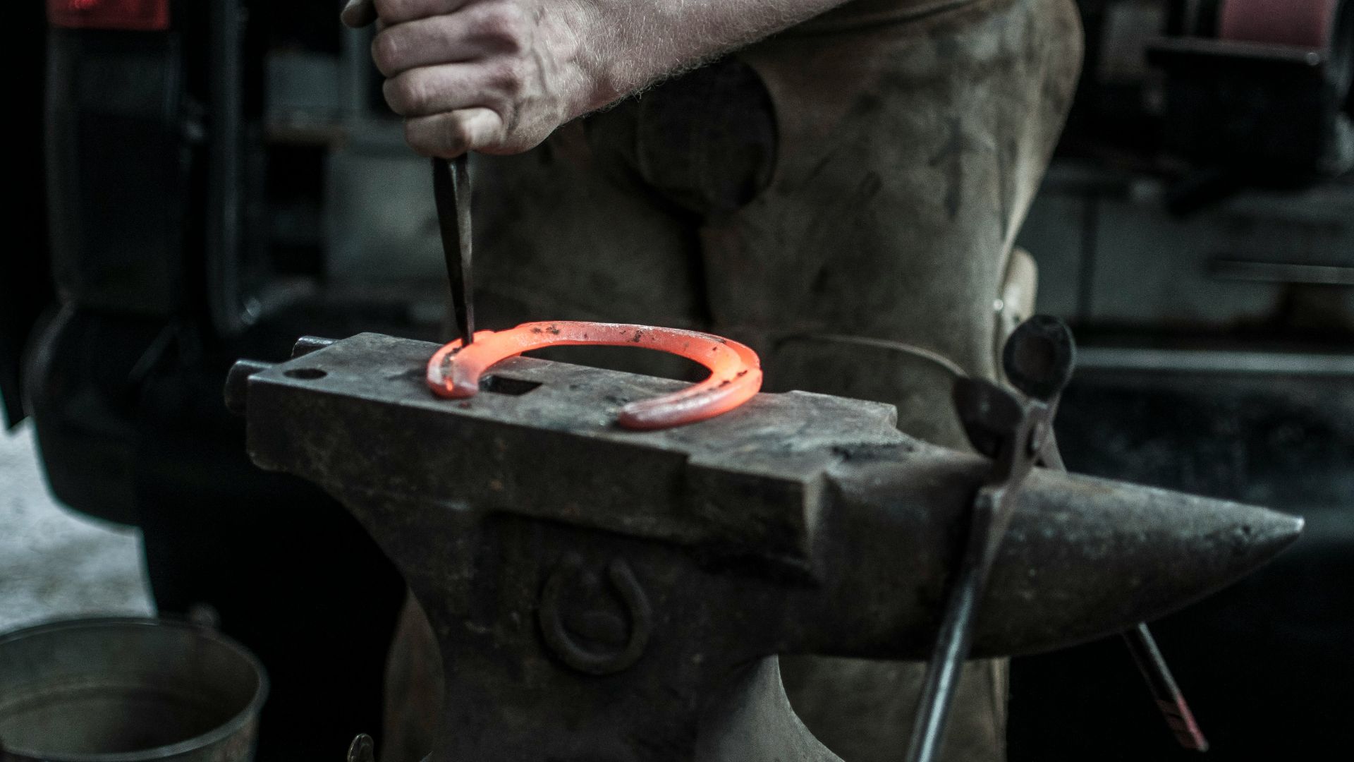 man forging horseshoe