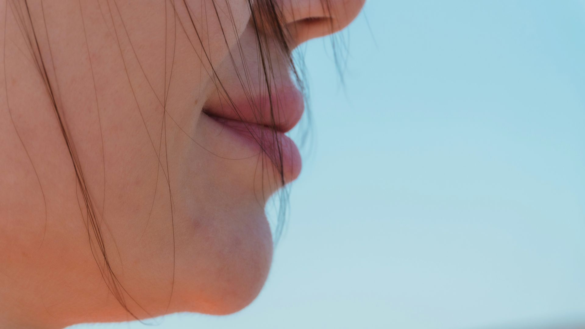 Close-up profile of a person's mouth and chin