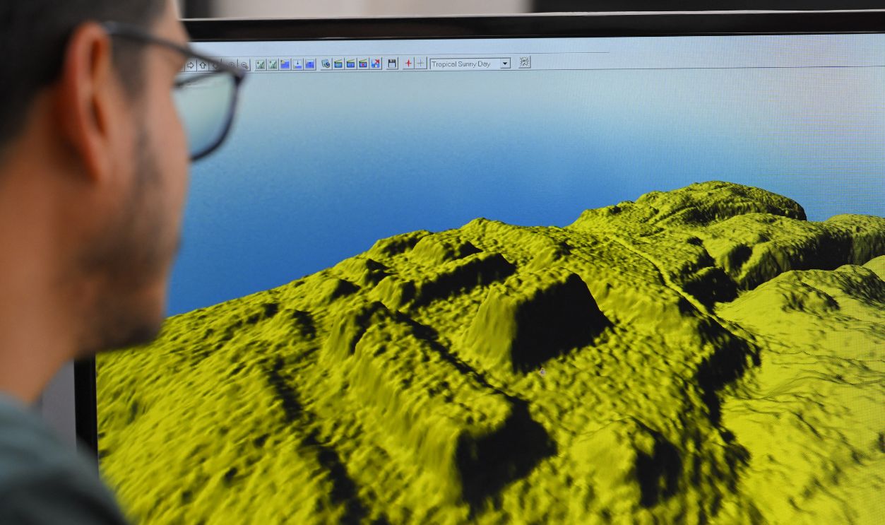 Geomatics analyst at the Institute of Cultural Heritage, Leonardo Auz, shows a digital representation of the relief of an area near the Upano River in the Ecuadorian Amazon, where there would be monumental archaeological remains, at the institute's headquarters in Quito on January 31, 2024. The thickness of the forest protected them for thousands of years, but the passage of machinery and natural erosion have put at risk enormous mounds of an ancient Amazonian civilization in the Upano valley, in Ecuador, where strategies for the conservation of a 