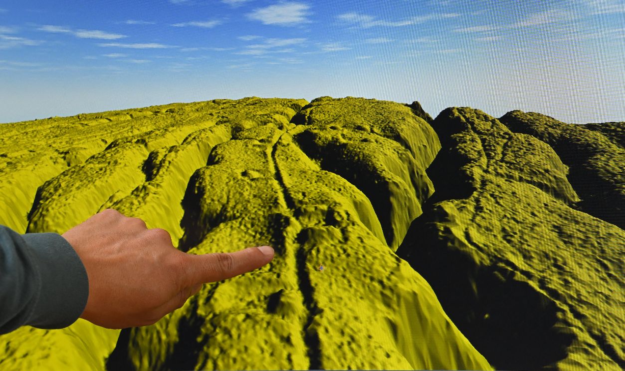 Geomatics analyst at the Institute of Cultural Heritage, Leonardo Auz, shows a digital representation of the relief of an area near the Upano River in the Ecuadorian Amazon, where there would be monumental archaeological remains, at the institute's headquarters in Quito on January 31, 2024. The thickness of the forest protected them for thousands of years, but the passage of machinery and natural erosion have put at risk enormous mounds of an ancient Amazonian civilization in the Upano valley, in Ecuador, where strategies for the conservation of a 