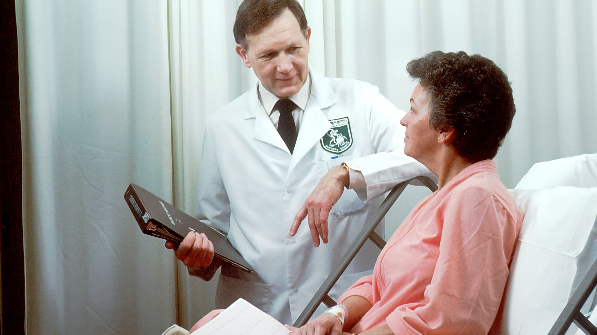 man in white button up shirt holding black tablet computer
