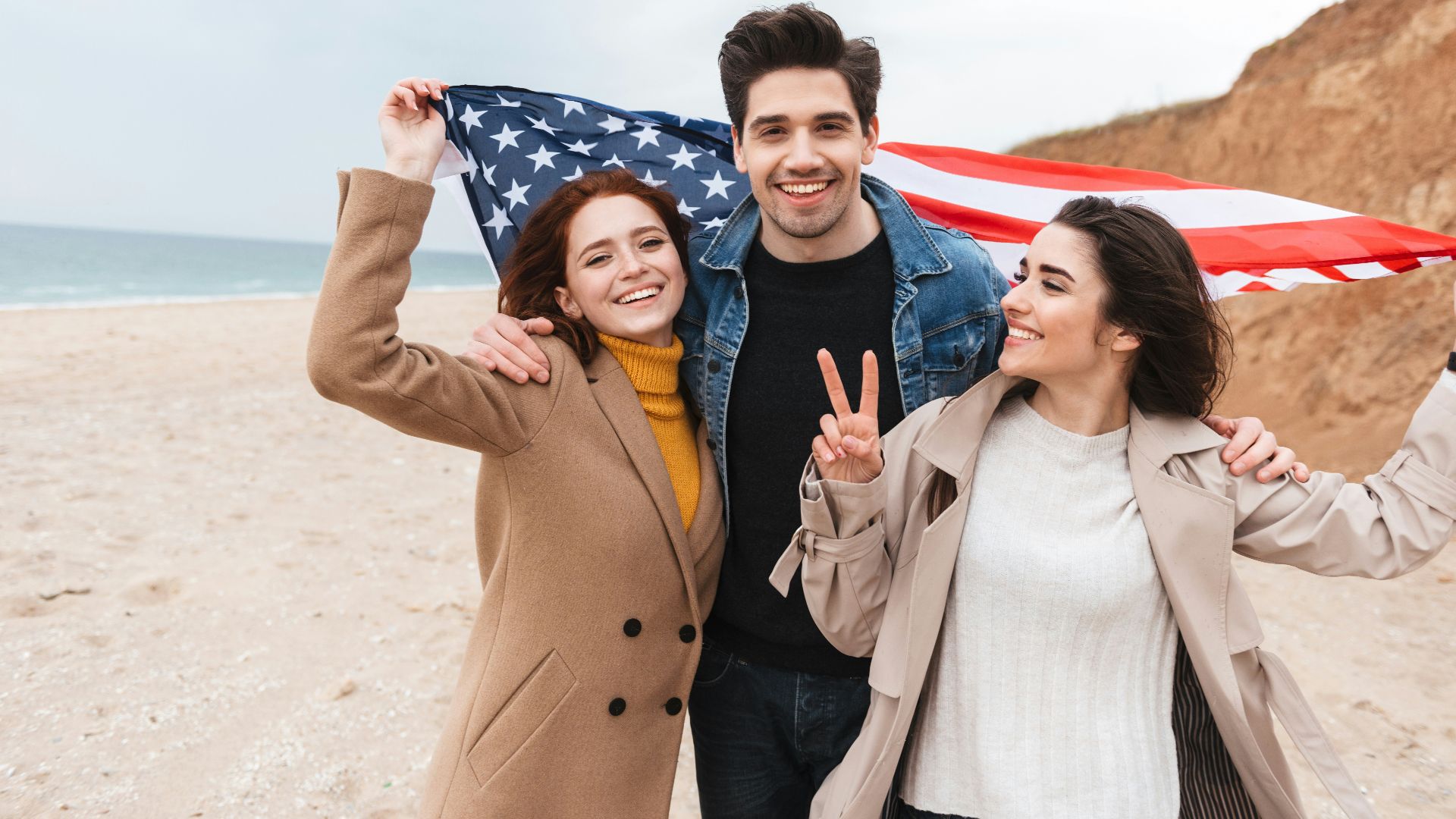a couple of people that are standing in the sand
