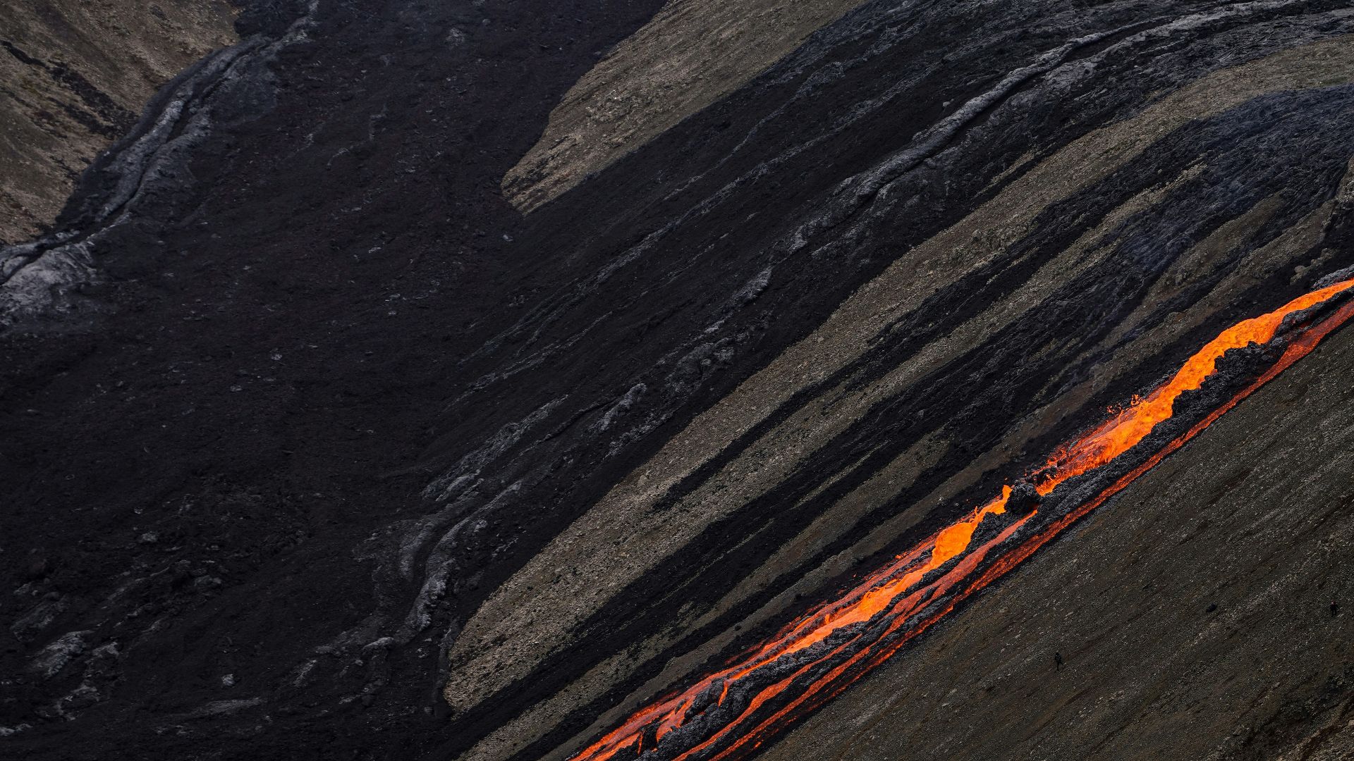 a train is going down a track in the mountains