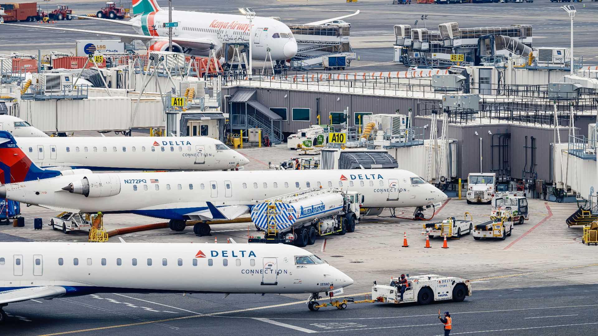 Airplanes are parked at an airport terminal.