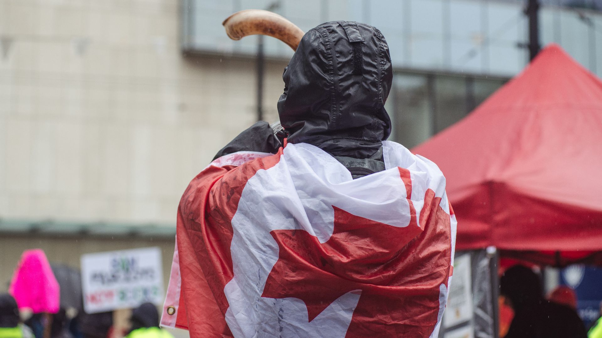 a statue of a man with a canadian flag draped around his shoulders