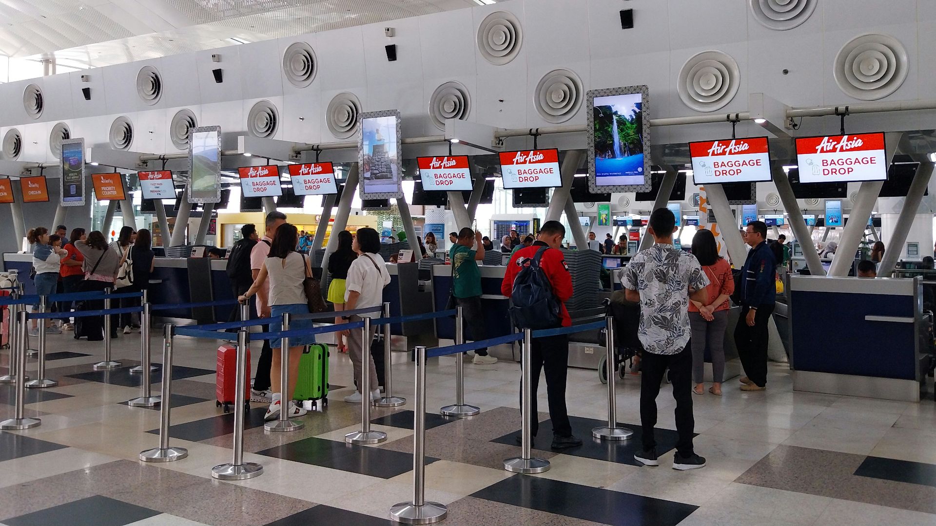 A group of people waiting in line at an airport