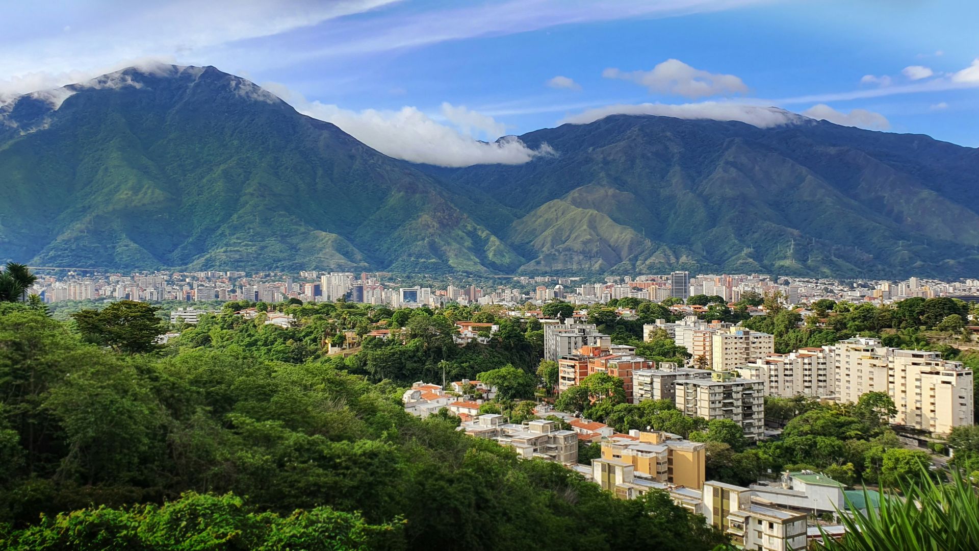 a view of a city with mountains in the background