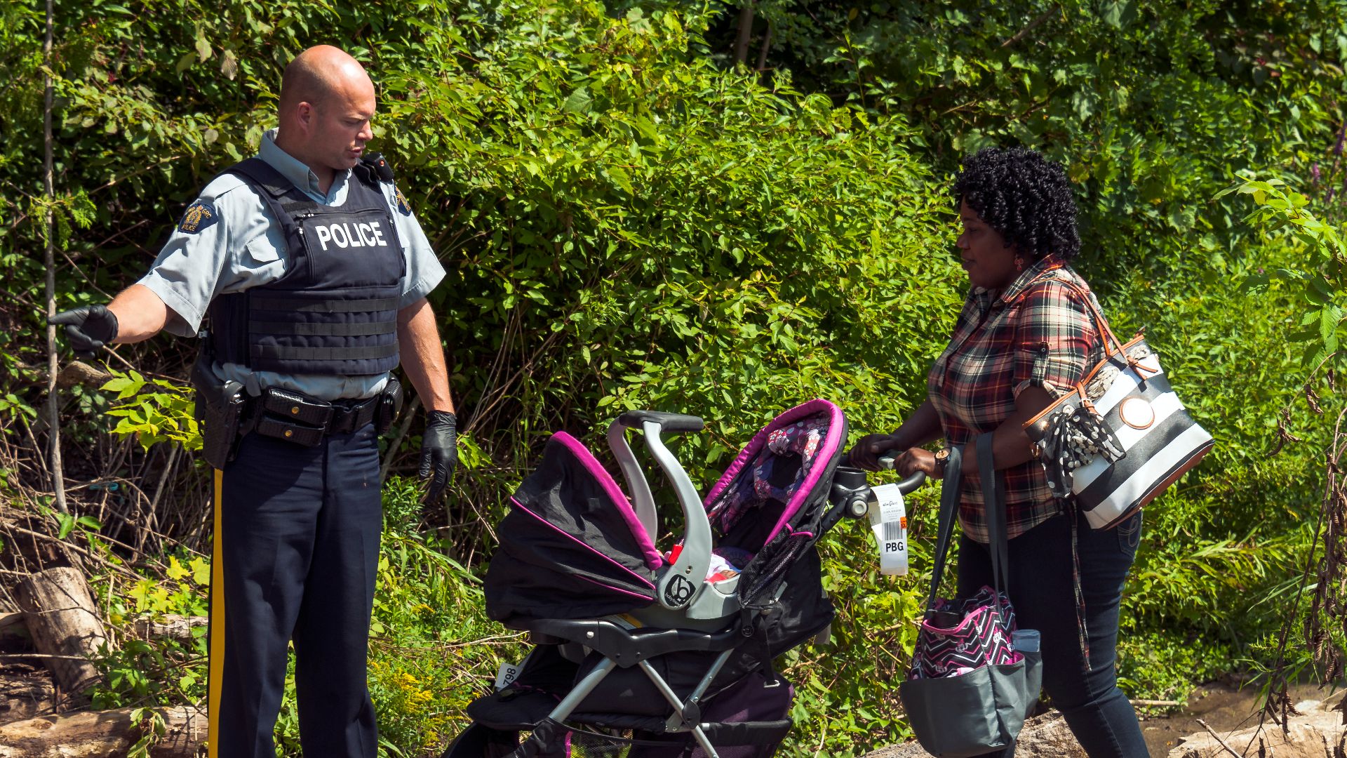 File:Woman with stroller crossing Canadian border despite this not being an official entry point in order to request asylum, Champlain, NY-Lacolle, QC.jpg