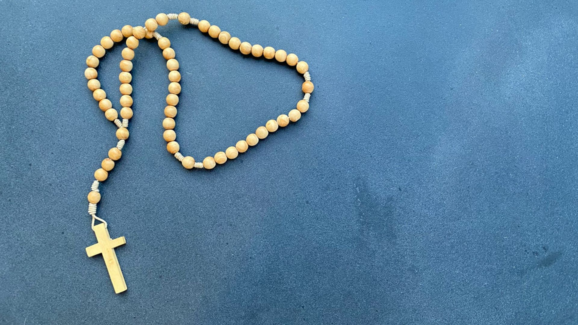 a rosary with a wooden cross on it