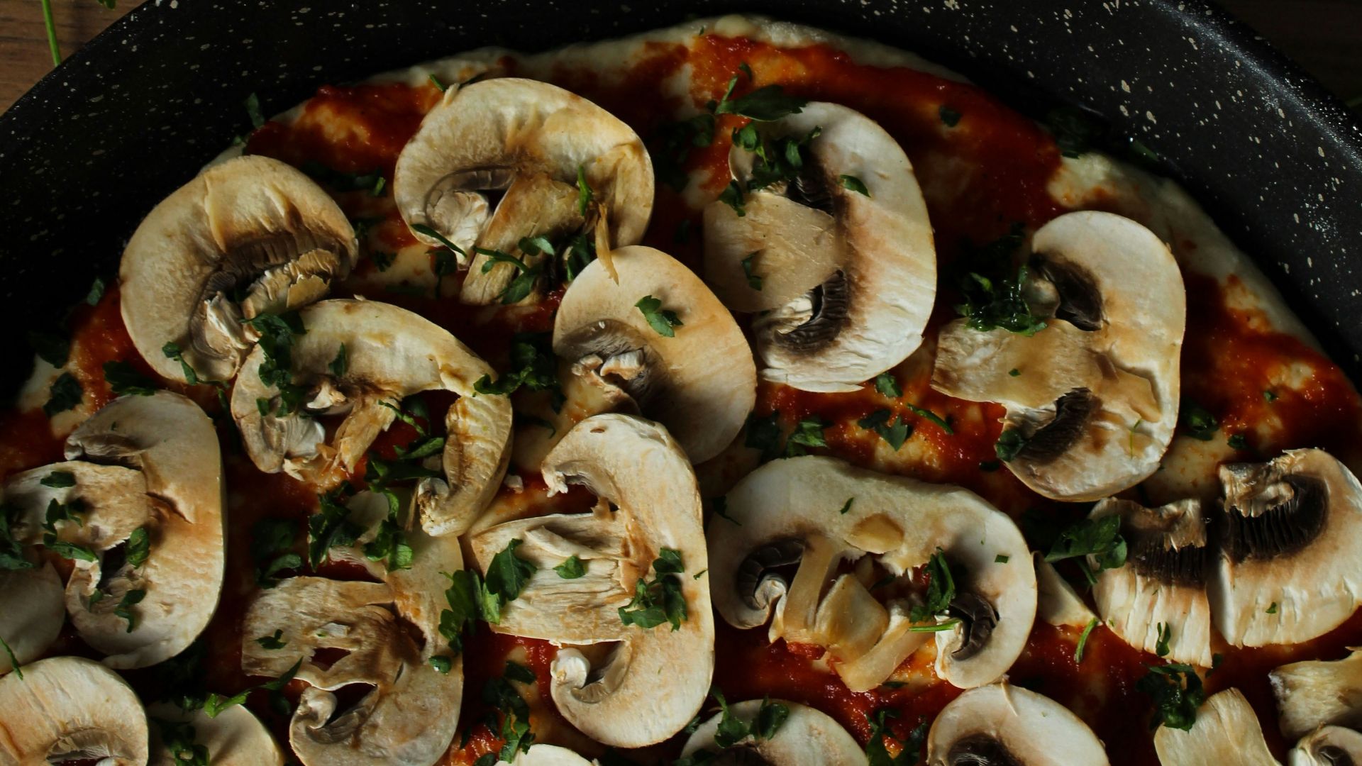 sliced mushroom on black ceramic plate