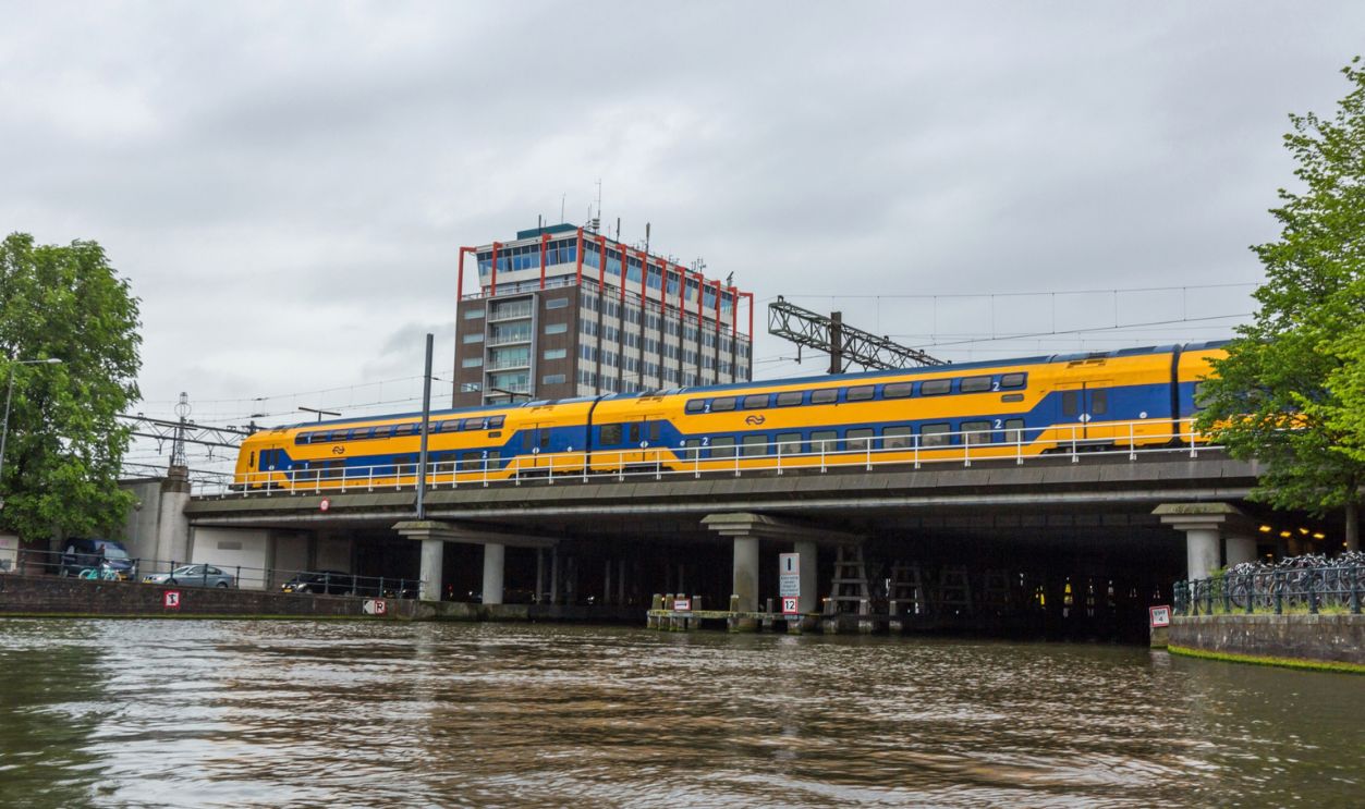 AMSTERDAM, NETHERLANDS - JUNE 12, 2016: Passenger Trains NS Intercity leaving Amsterdam Central Station. Nederlandse Spoorwegen is the largest rail transport operator in NL.
