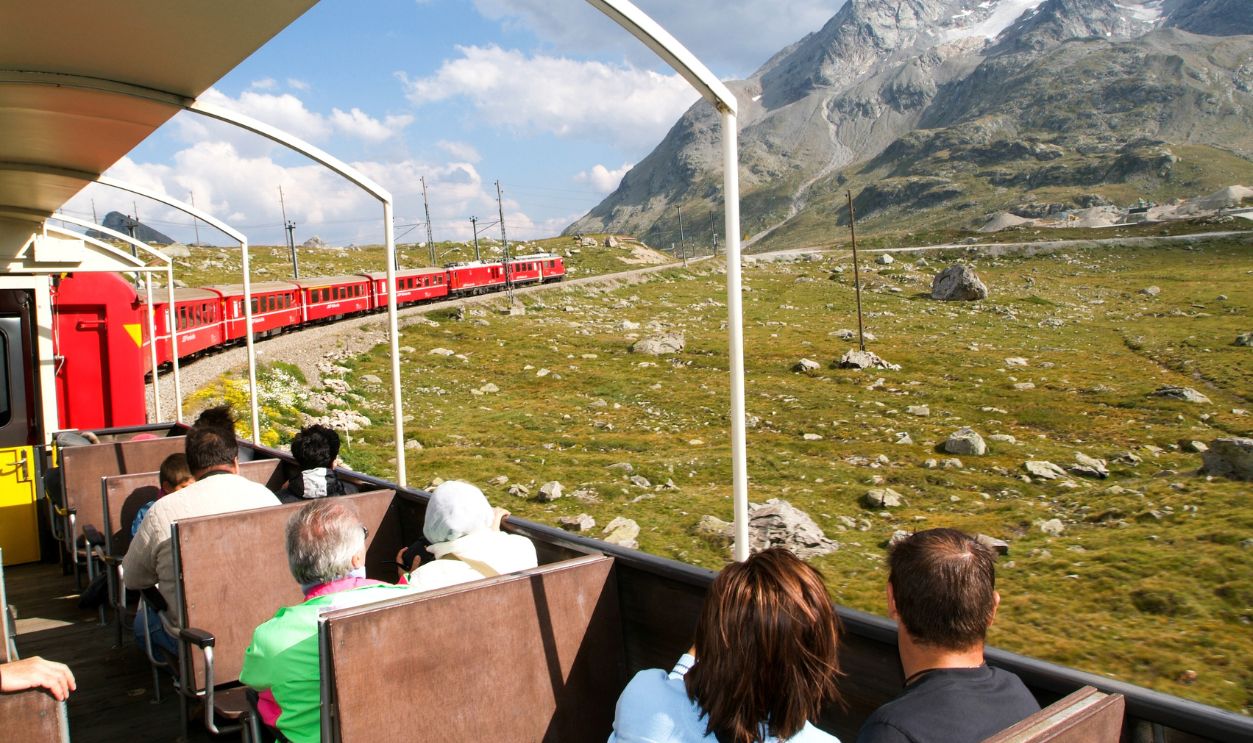 Bernina Express, Switzerland - 21 July 2015: People sitting on the Bernina express train and admiring the scenic view on the Swiss alps