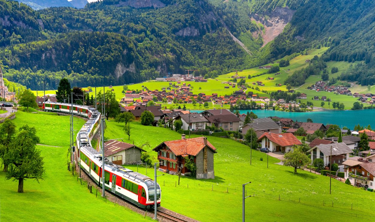 Famous electric red tourist panoramic train in swiss village Lungern, canton of Obwalden, Switzerland