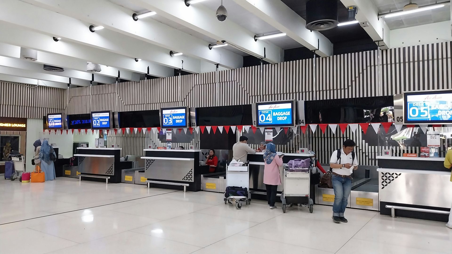 a group of people waiting in line at an airport