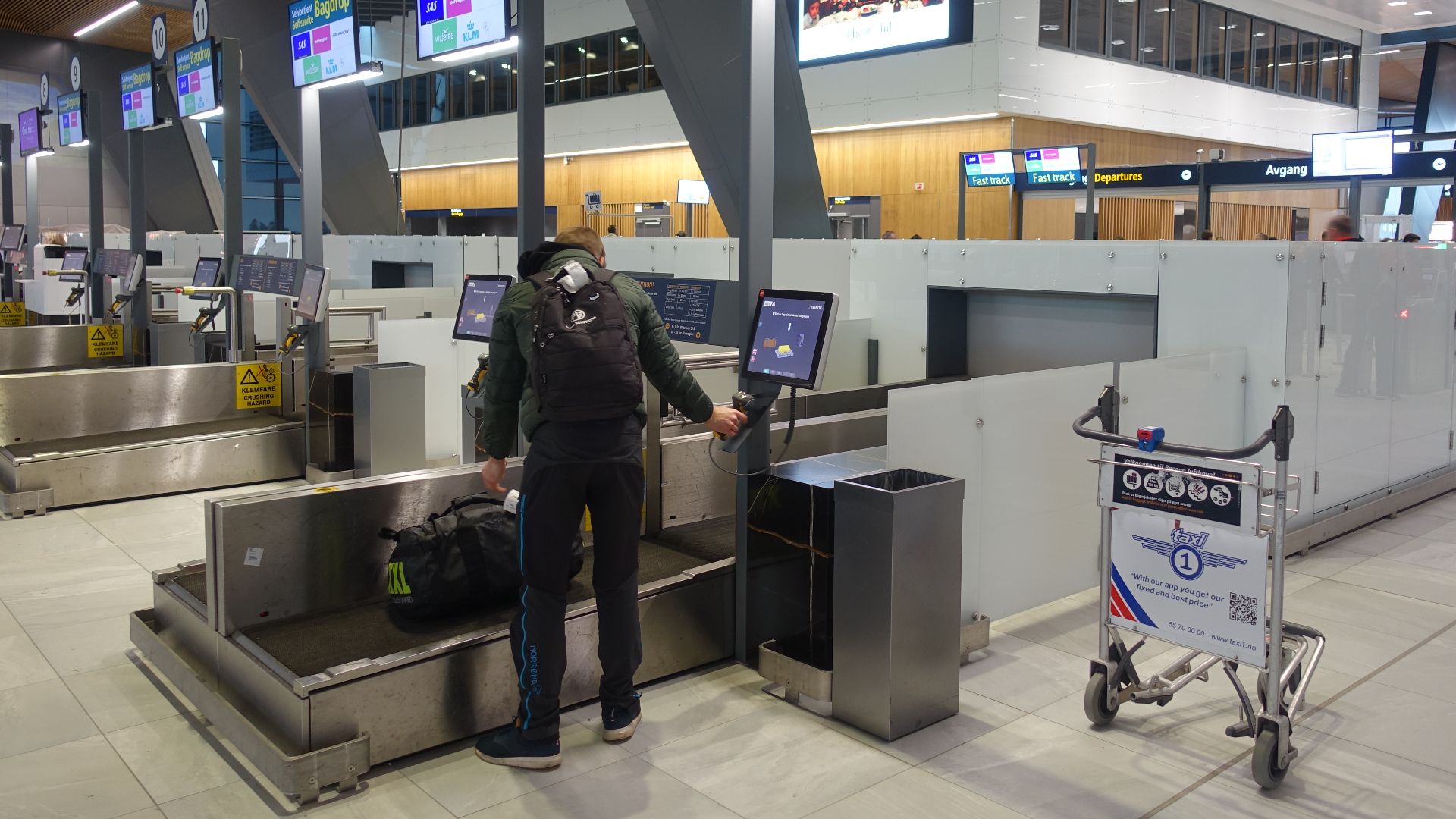 Self-service Bag drop for registration and sending checked bags and luggage: a self-check-in process allowing passengers with bags to check-in at Self Bag Drop machines where they attach the baggage tag and drop the bag at the baggage drop belt (conveyor
