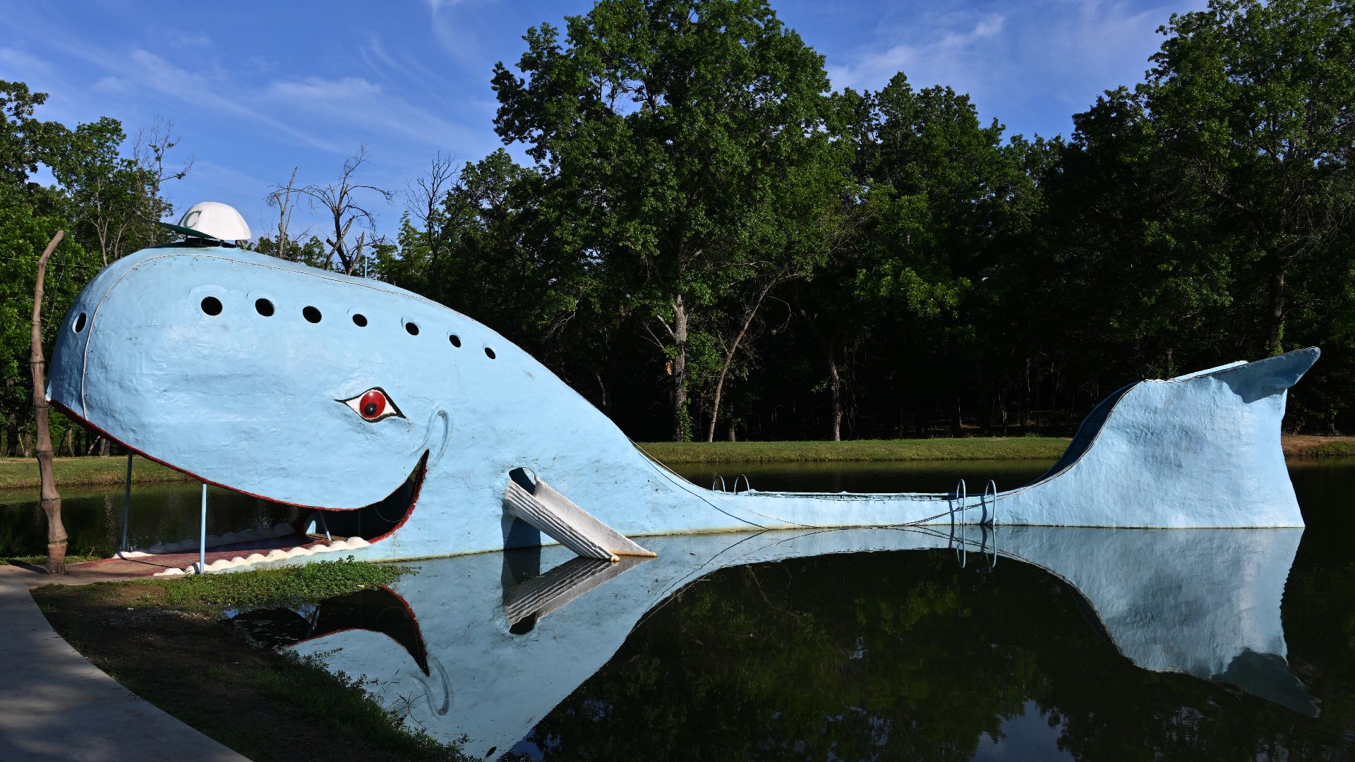 The Blue Whale and it's reflection.  It was built as an anniversary present that became a popular swimming spot.  The City of Catoosa bought the property in 2020 and currently maintains it. 2600 OK-66, Catoosa, Oklahoma 74015.
