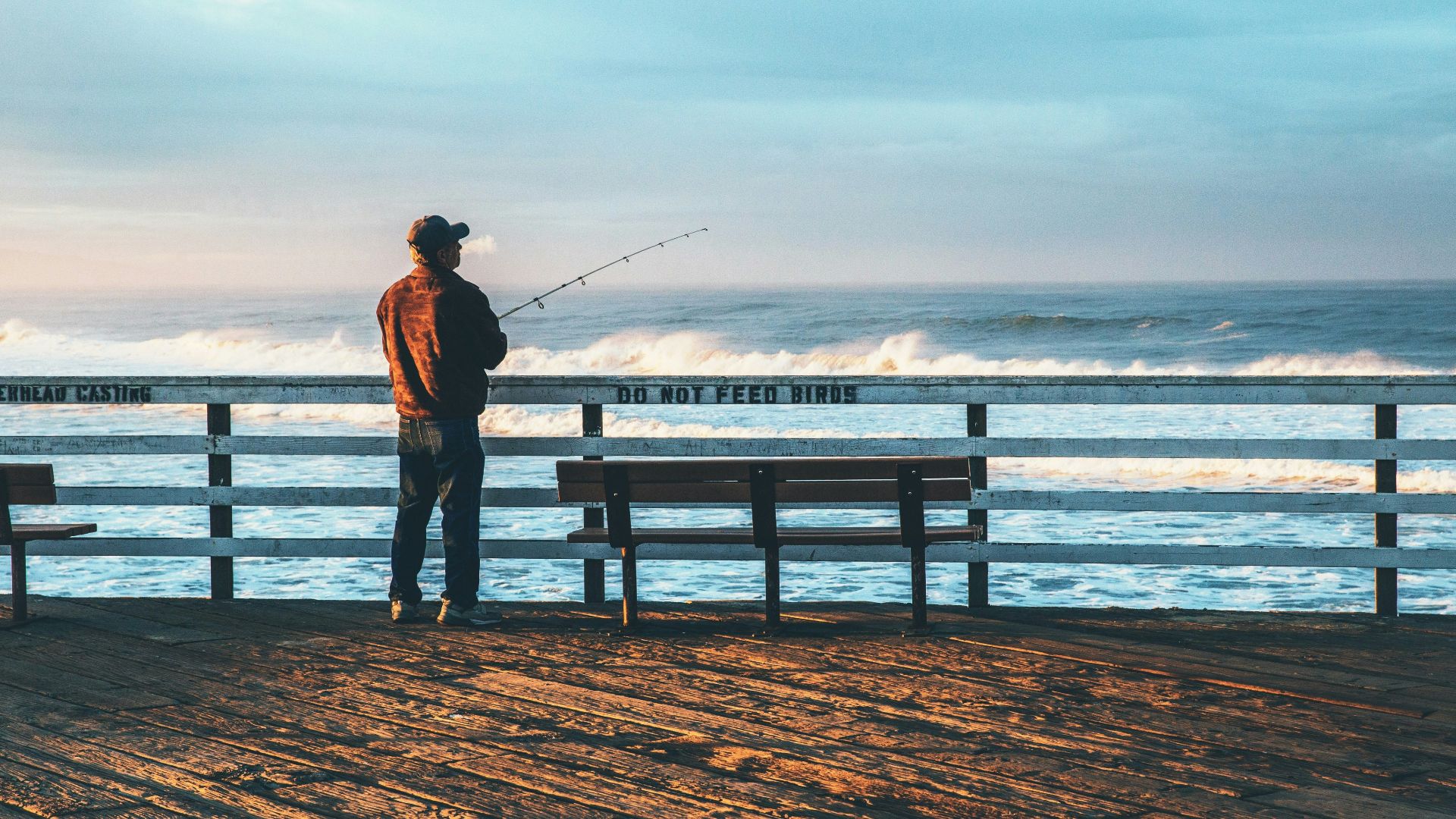 man fishing on seaside