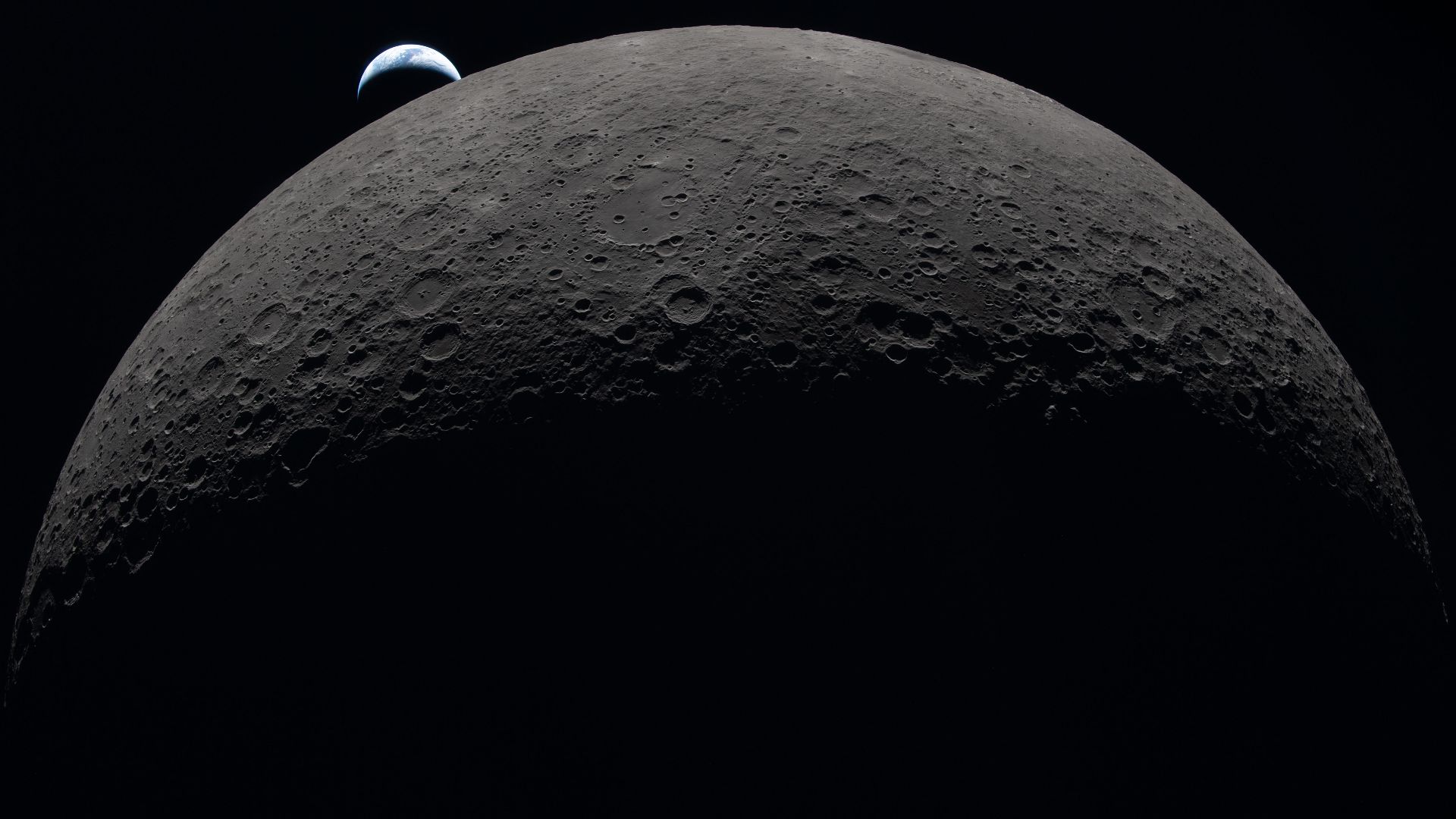 art002e009287 (April 6, 2026) – Earth sets at 6:41 p.m. EDT, April 6, 2026, over the Moon’s curved limb in this photo captured by the Artemis II crew during their journey around the far side of the Moon. Orientale basin is perched on the edge of the visib