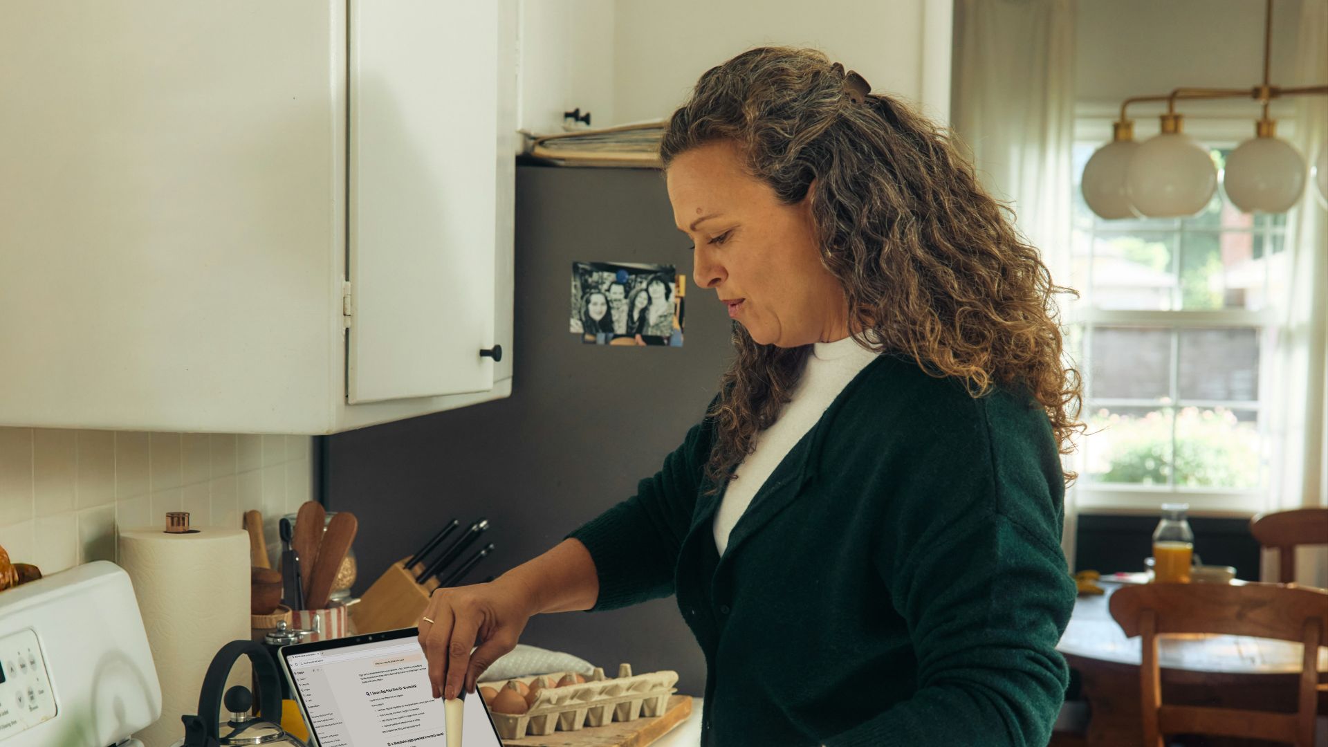 Woman following recipe on tablet in kitchen