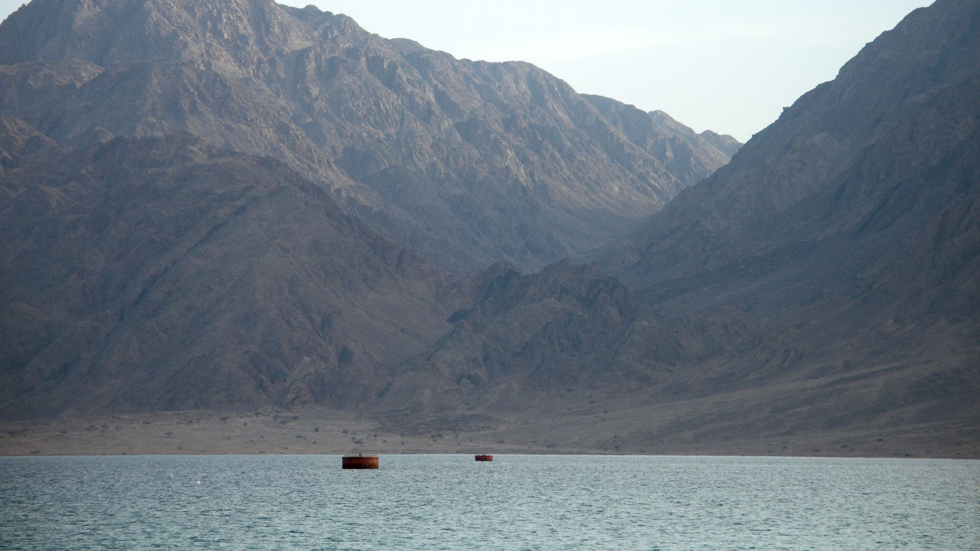Turquoise waters of Red Sea edged by beaches and rimmed on both sides by barren, rugged mountain chains give Nuweiba the attractive setting. Nuweiba, Sinai, Egypt.