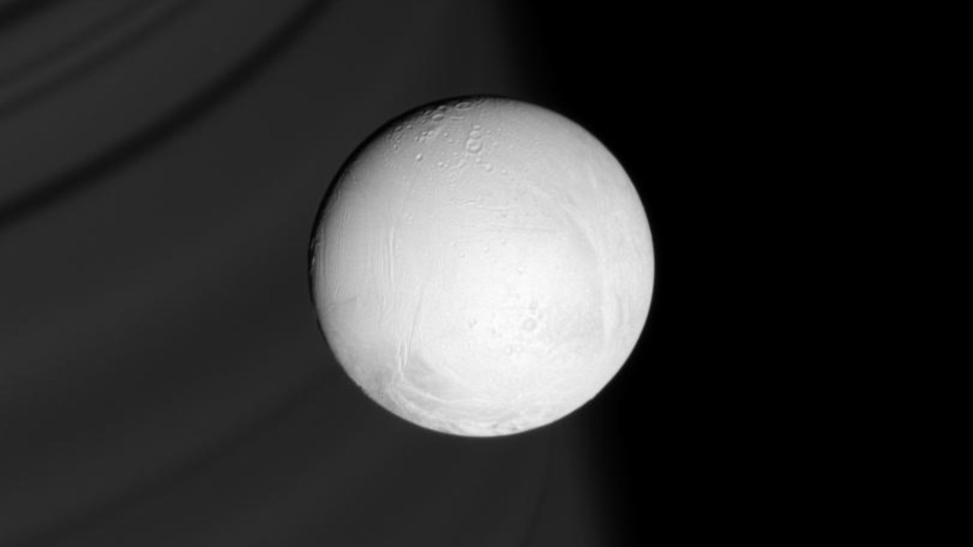 Ring shadows line the face of distant Saturn, providing a backdrop for the brilliant, white sphere of Enceladus. This icy moon, with its heavily modified surface and towering plume of icy material, is a target of intense study for Cassini during its Equin