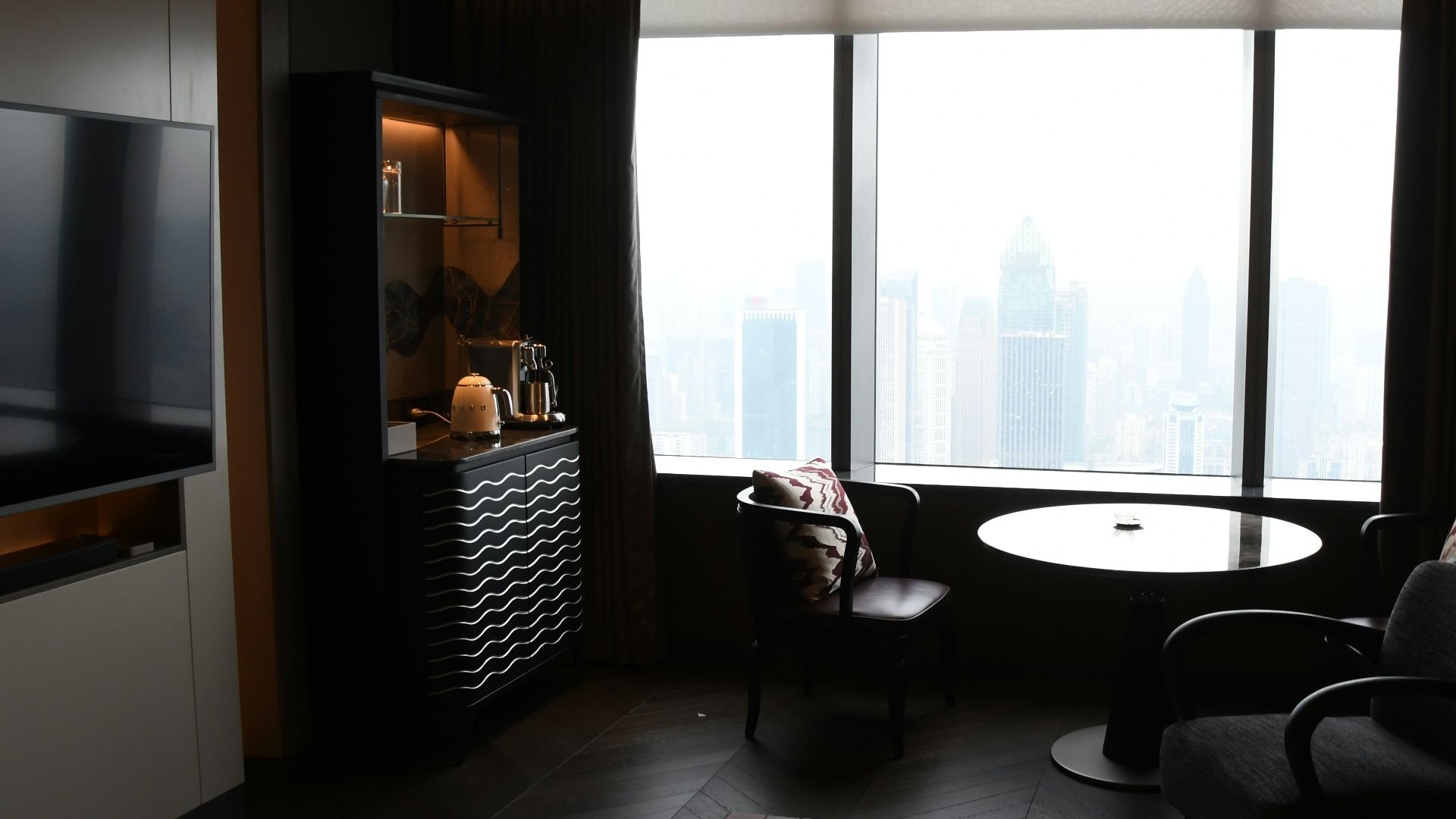 Modern living room with city view through window