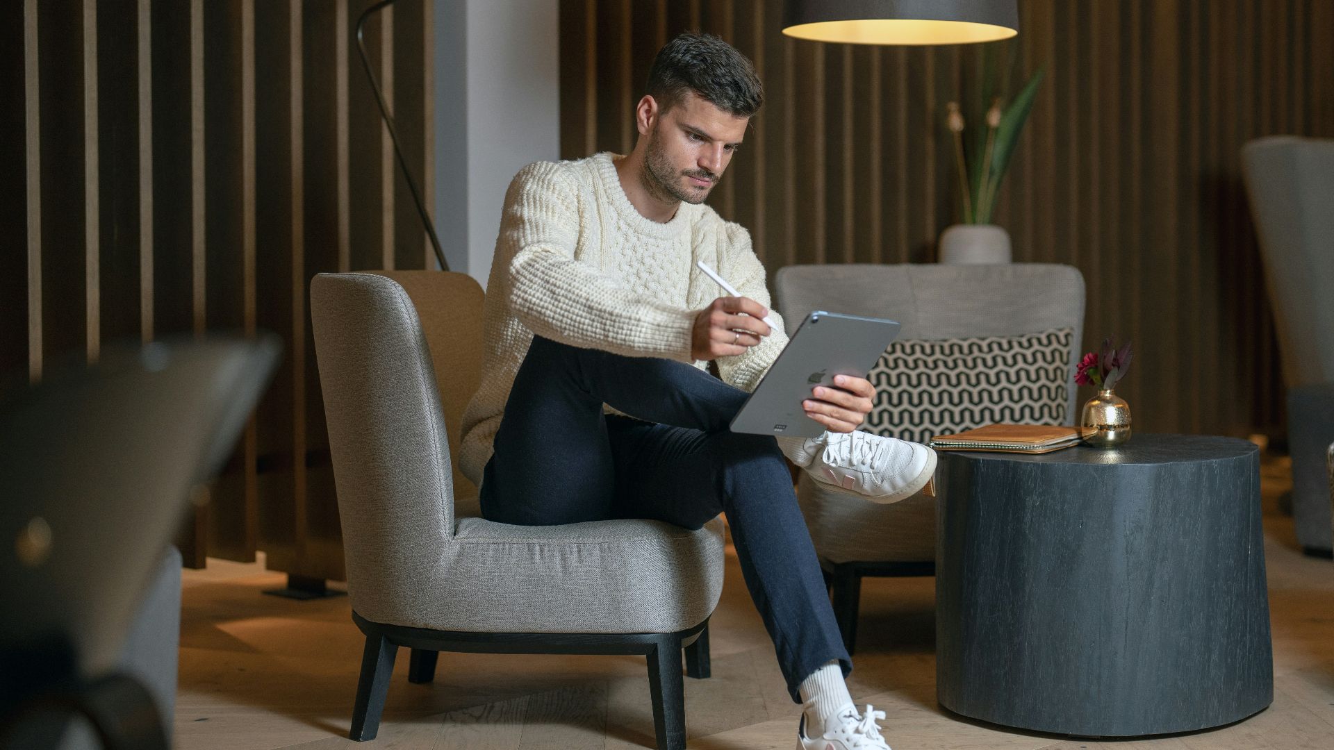 a person sitting in a chair with a laptop