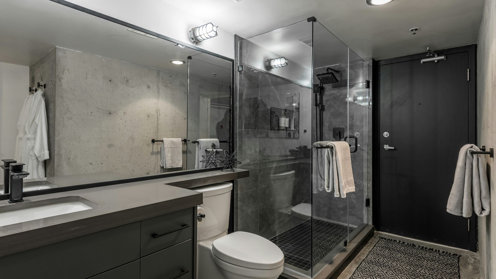 a bathroom with a shower, toilet and sink