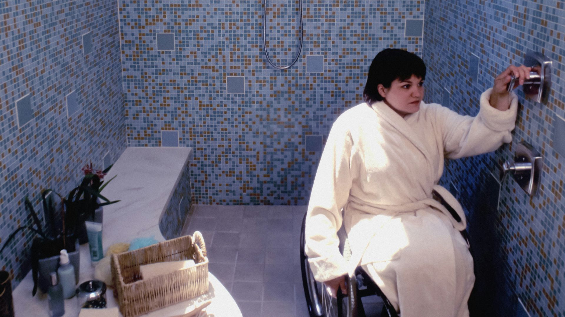 a person in a wheelchair in a bathroom