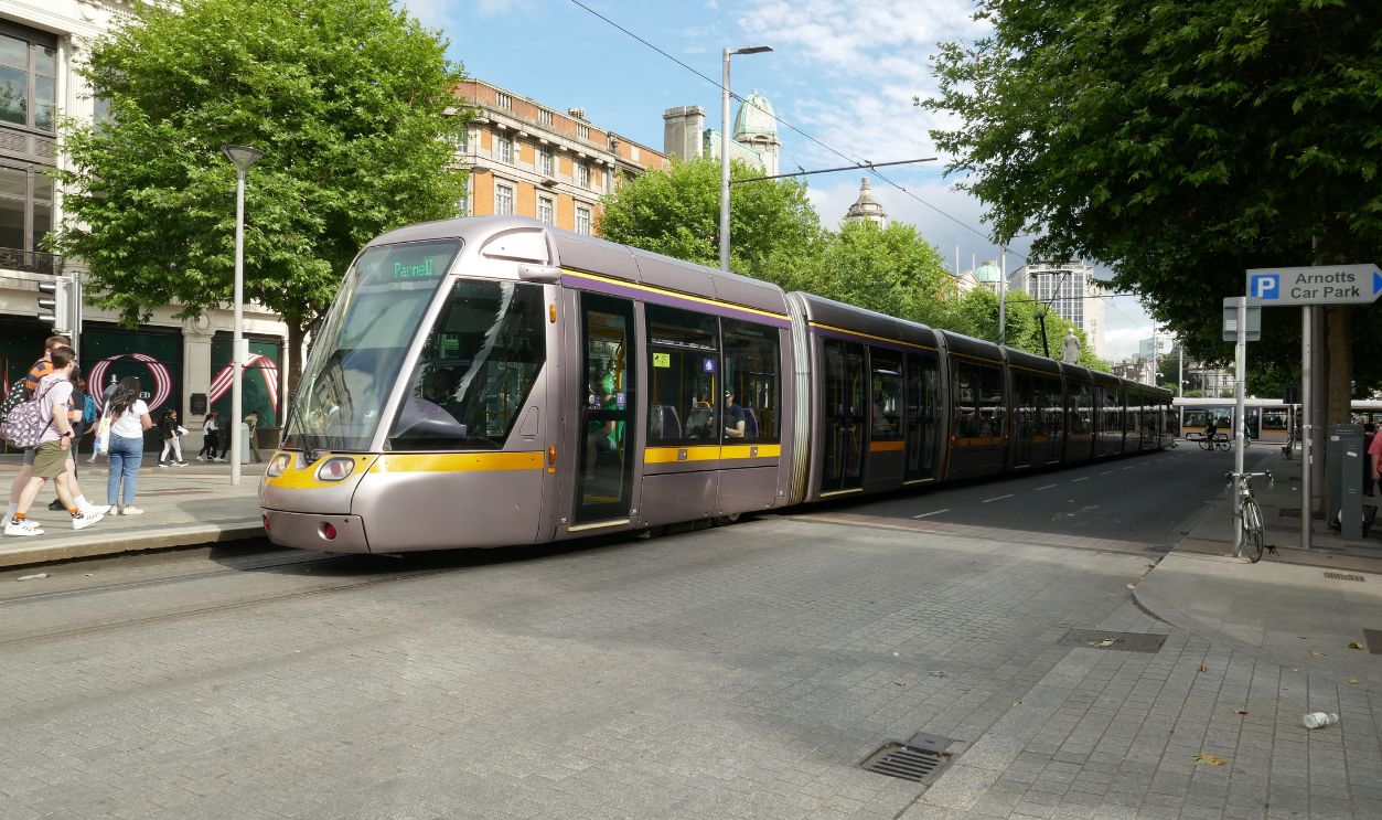 dublin, ireland - june 28, 2023: a tram or luas in dublin ireland passing by on the street, public transportation