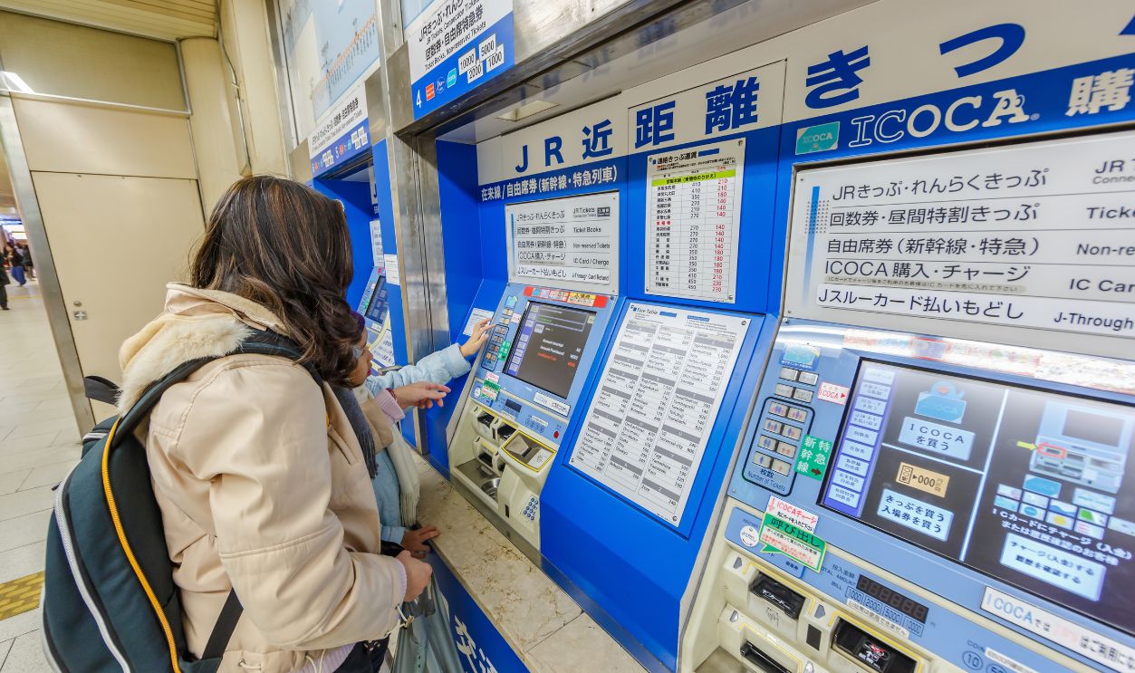 OSAKA - APR 8: Tourists buy ticket from Ticket vending machine in Kyoto Station on Apr 8, 14 in Kyoto. It is a major railway station and transportation hub in Kyoto.